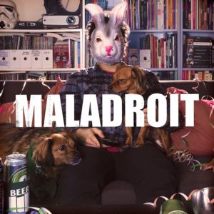 pochette de l'album de maladroit intitulé freedom fries and freedom kisses représentant un homme assis, portant un masque de chat, avec deux chiens sur ses genoux