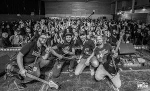 Les membres des Toys Breakers sont rassemblés sur scène et prennent un selfie avec leur public